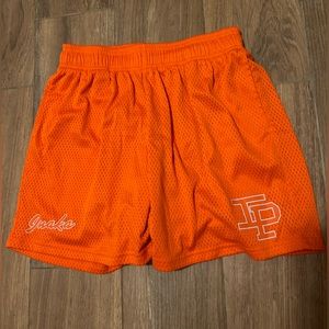 Orange Inaka mesh shorts.